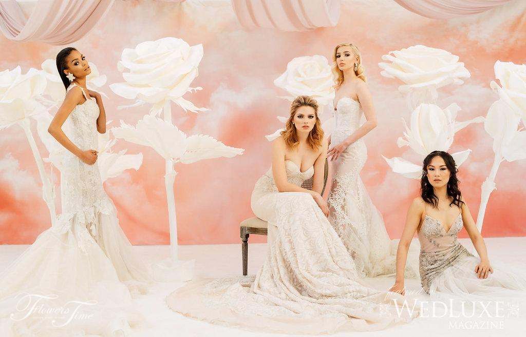 Four brides posing among giant white paper roses
