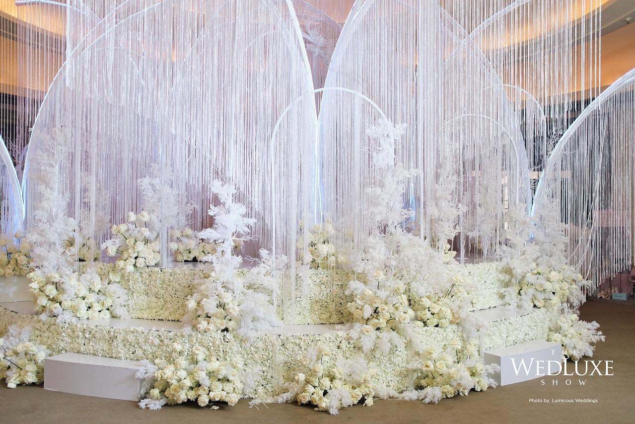 White floral stage under arches of crystal strands