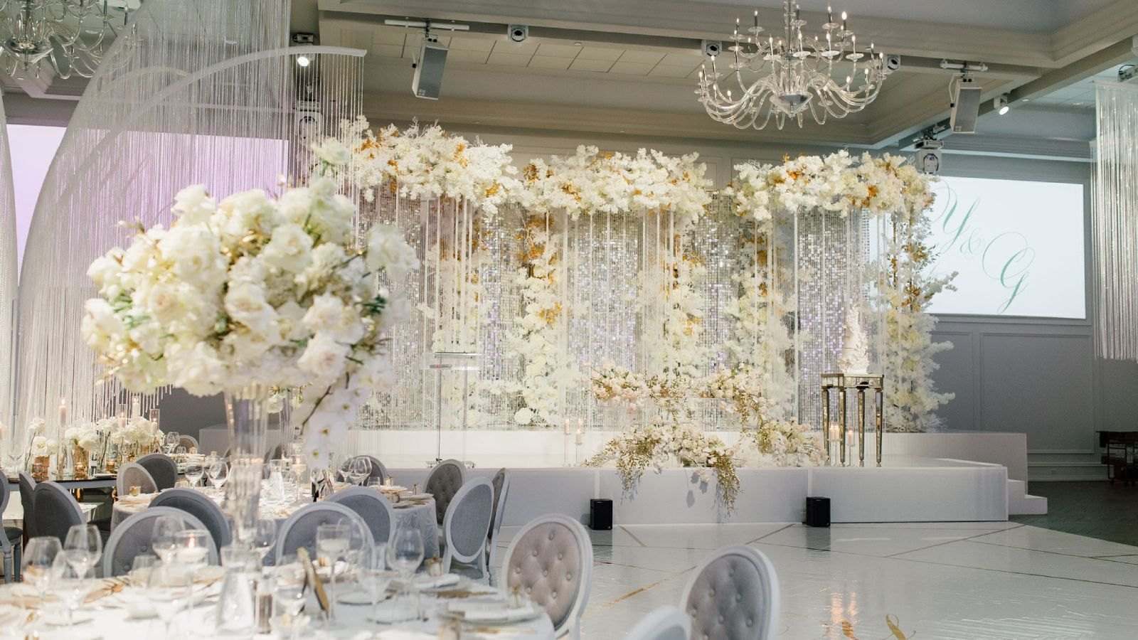 Cream floral wall with crystal strands behind a gala dance floor