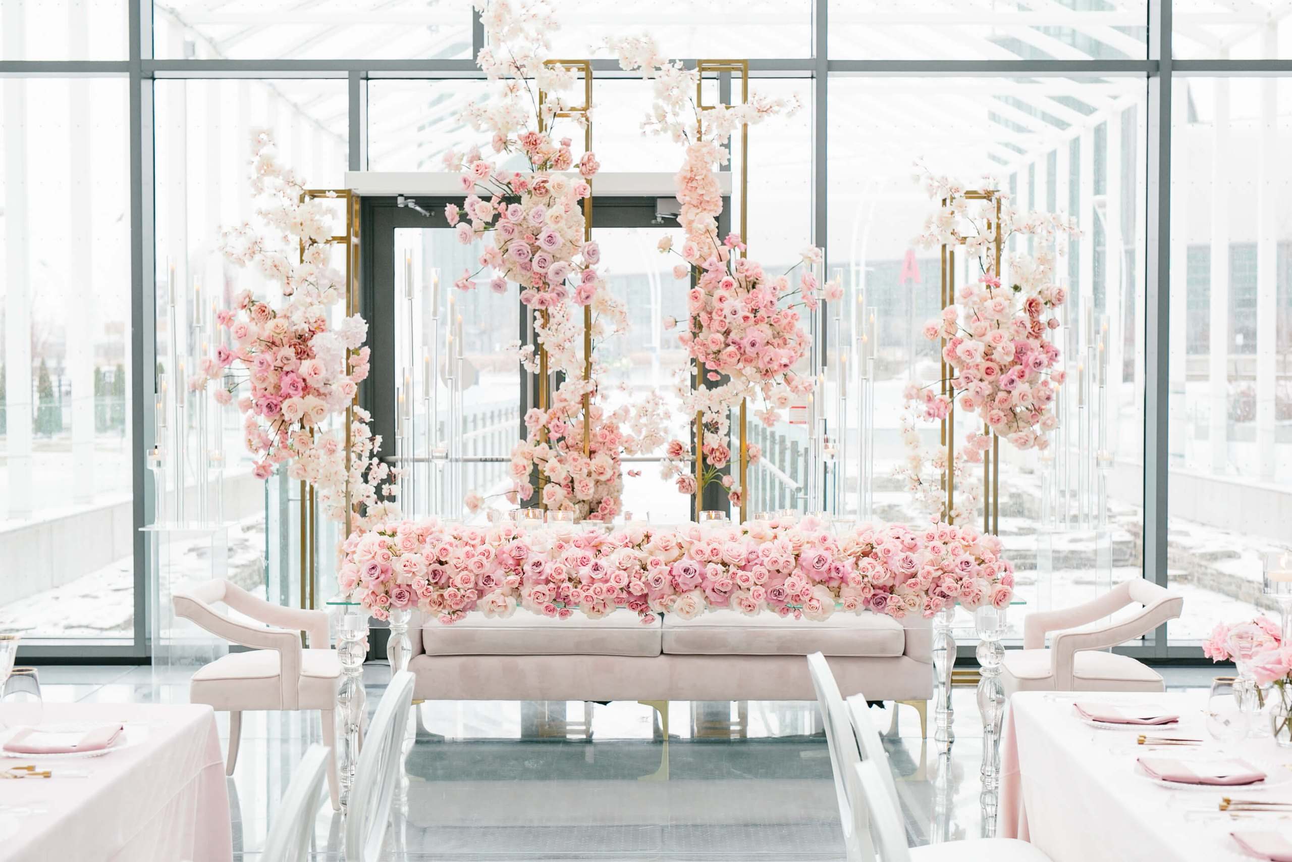Pink floral lounge set inside a glass pavilion