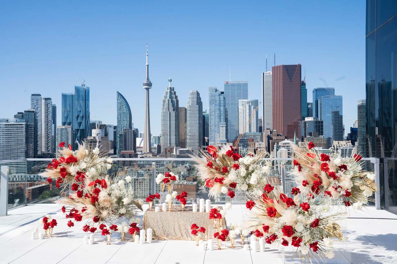 Rooftop dinner with red and pampas florals in front of the Toronto skyline