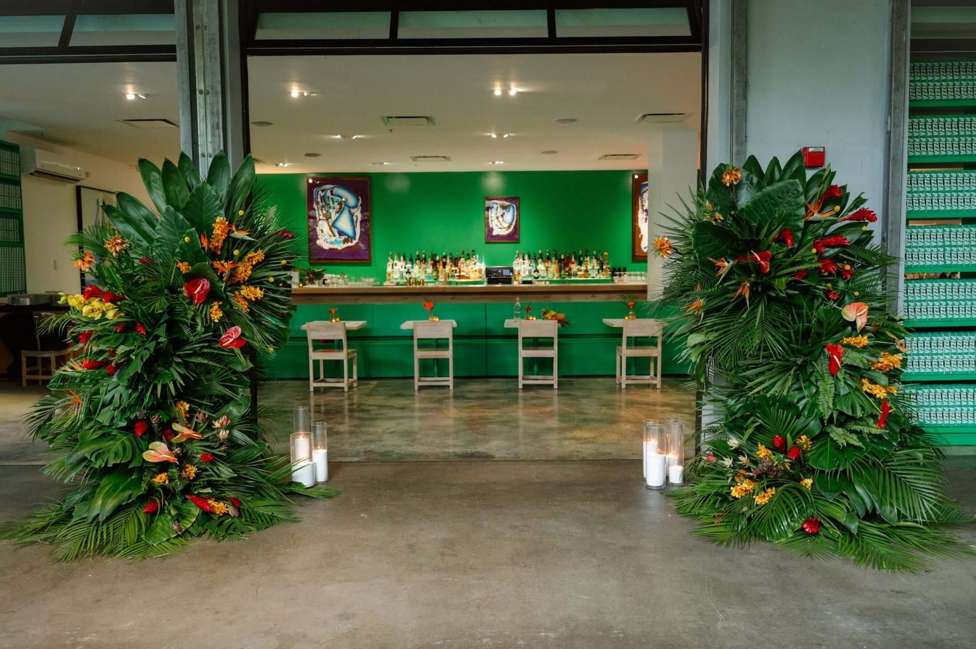 Emerald bar flanked by heliconia and palm arrangements